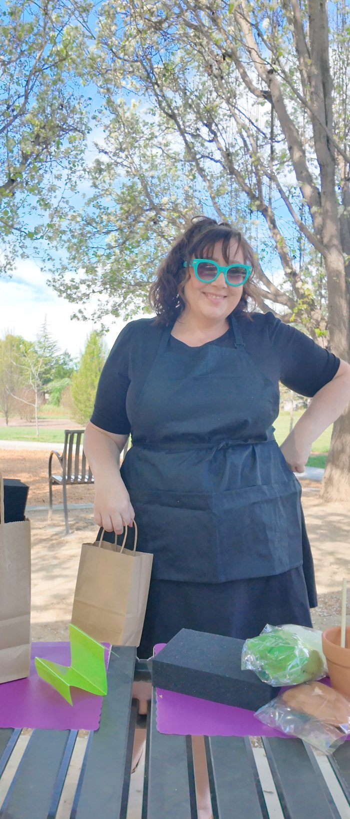 Nichole, founder of The Craft Break, outdoors with workshop supplies